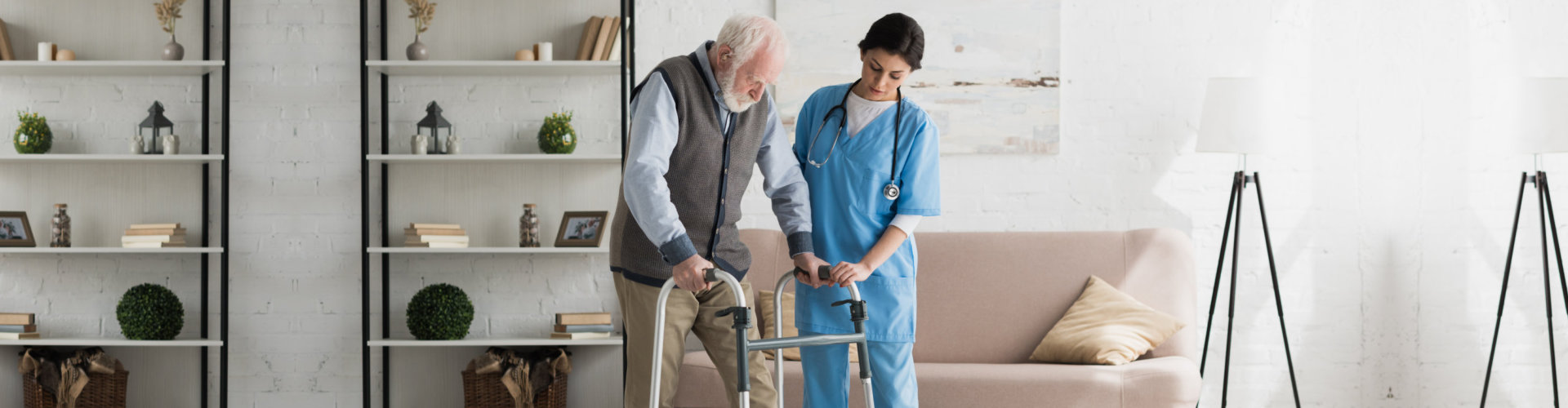 nurse assisting senior man to walk