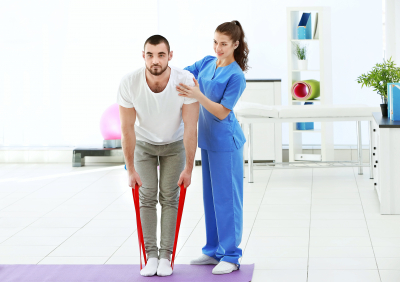 Physiotherapist working with patient in clinic